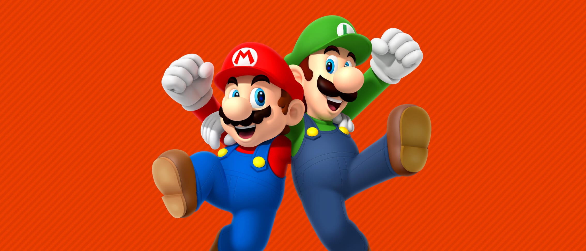 Closeup of Nintendo characters Mario and Luigi together in a side hug with their outer arms raised in a gesture.