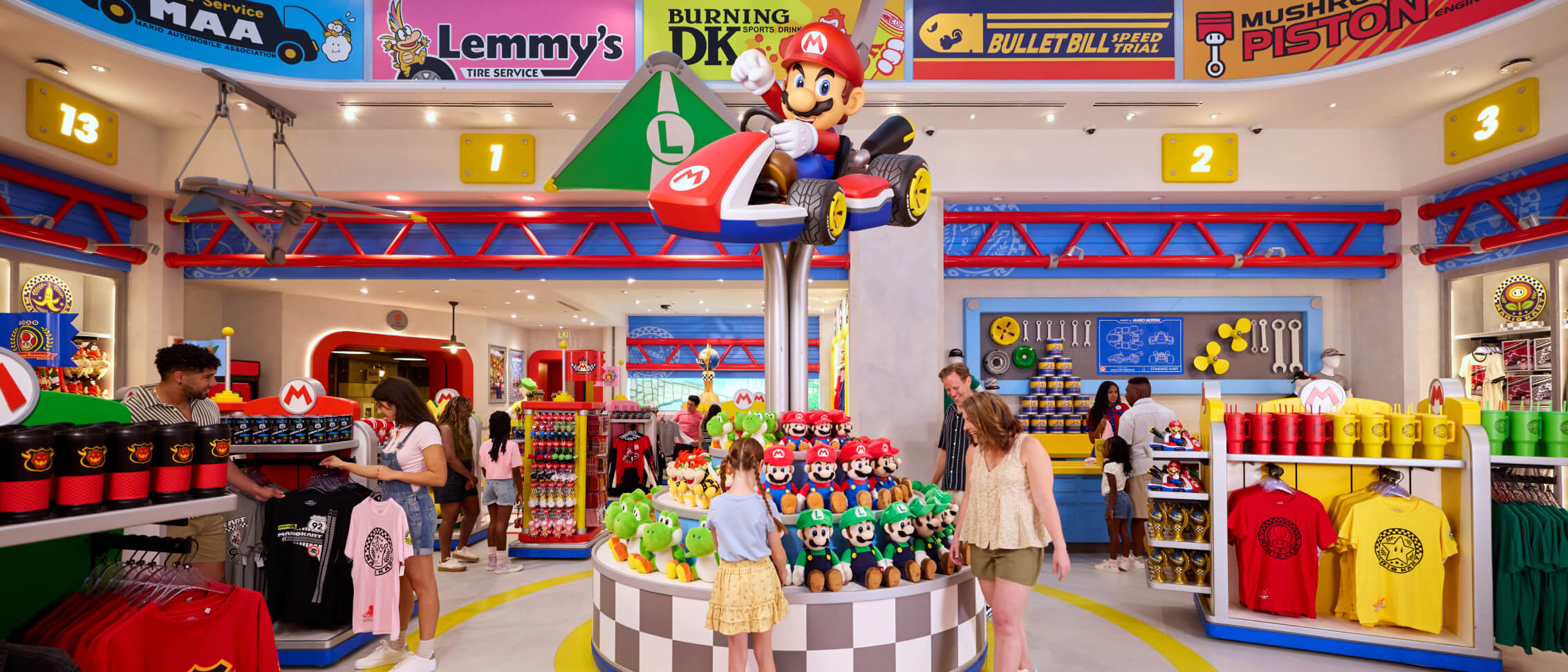 Excited Guests exploring a store filled with Super Mario-themed plush toys, apparel, cups and more.