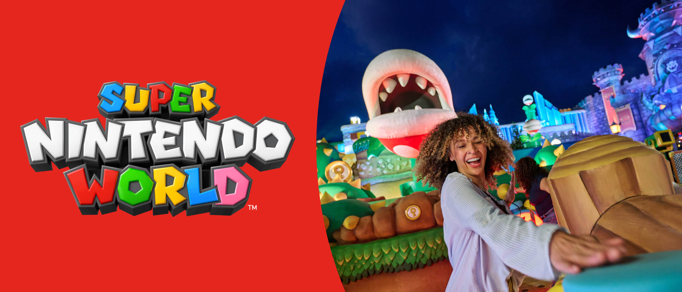 SUPER NINTENDO WORLD™ logo on red and an excited Guest tapping a surface at night amid a castle, a Piranha Plant and more.