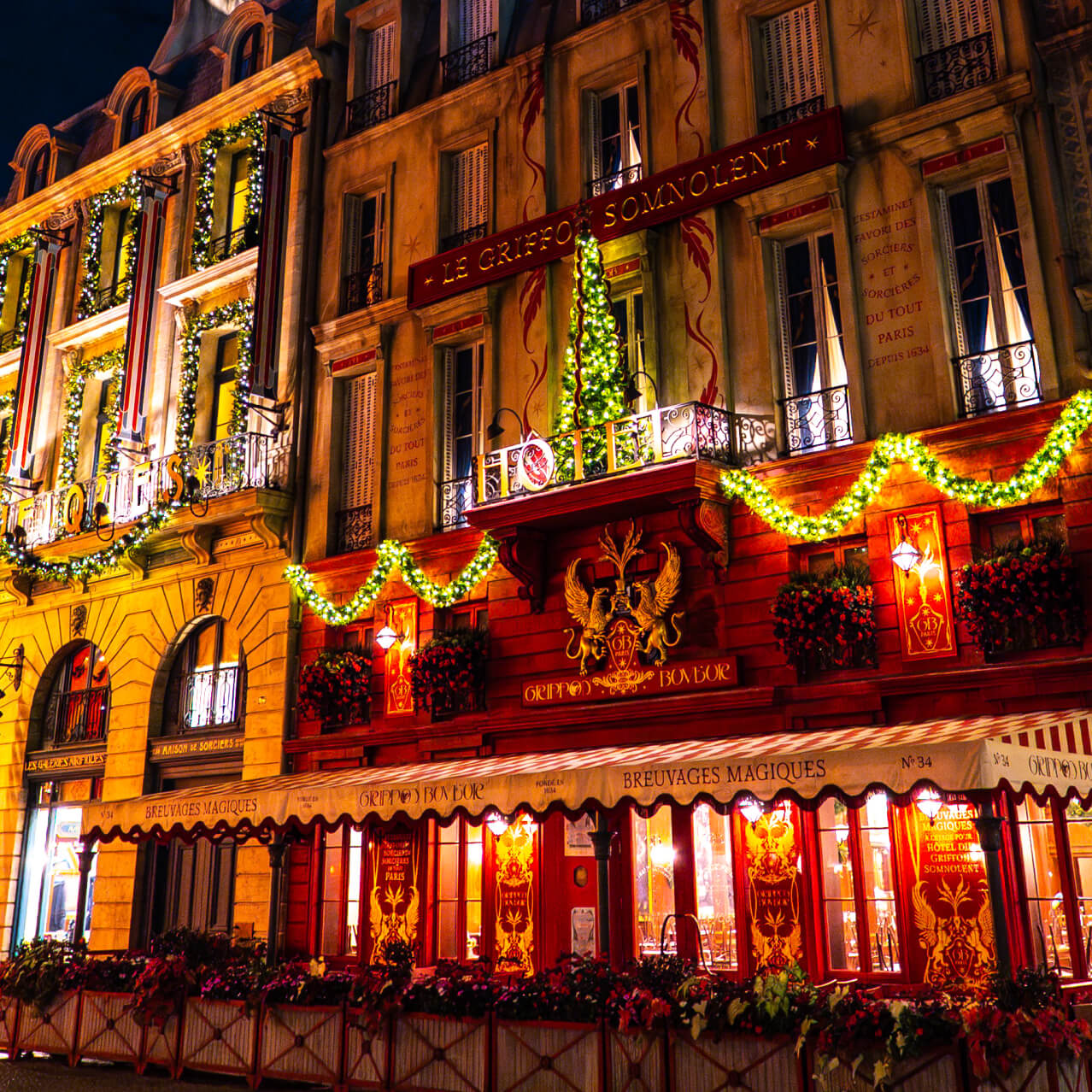 Illuminated garlands decorate storefronts in The Wizarding World of Harry Potter™ - Minstry of Magic™