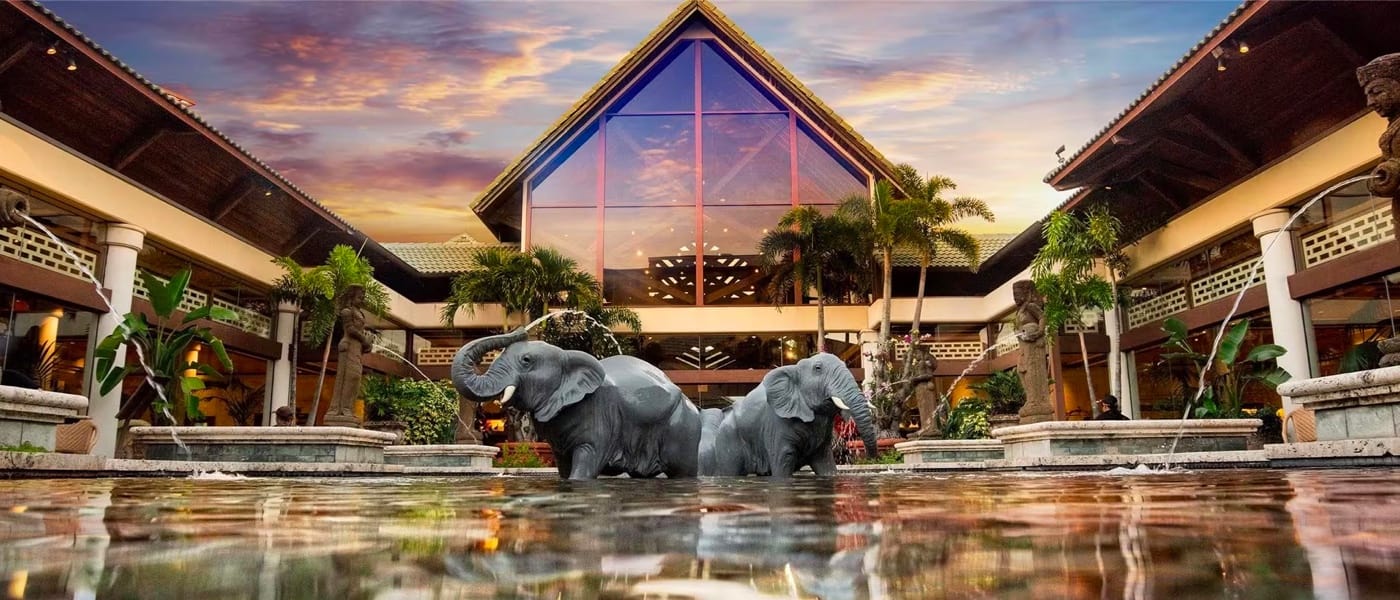 Elephant and tiki fountains spray into the water below in the Orchid Courtyard at Loews Royal Pacific Resort