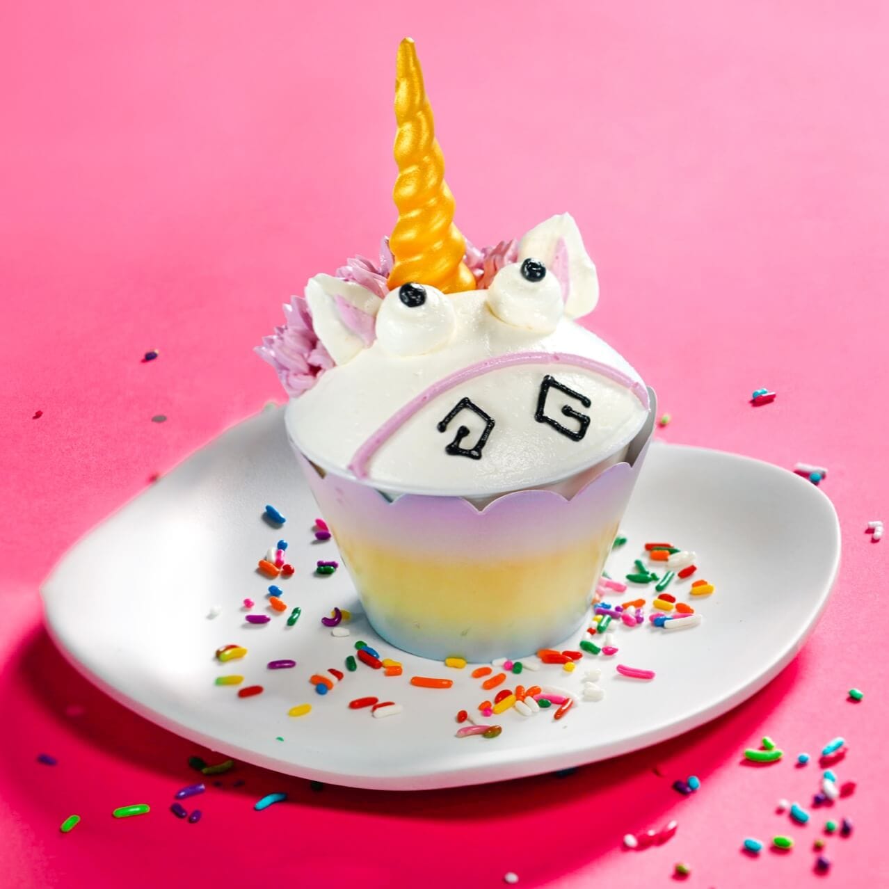 The Fluffy Unicorn Cupcake on a pink background.