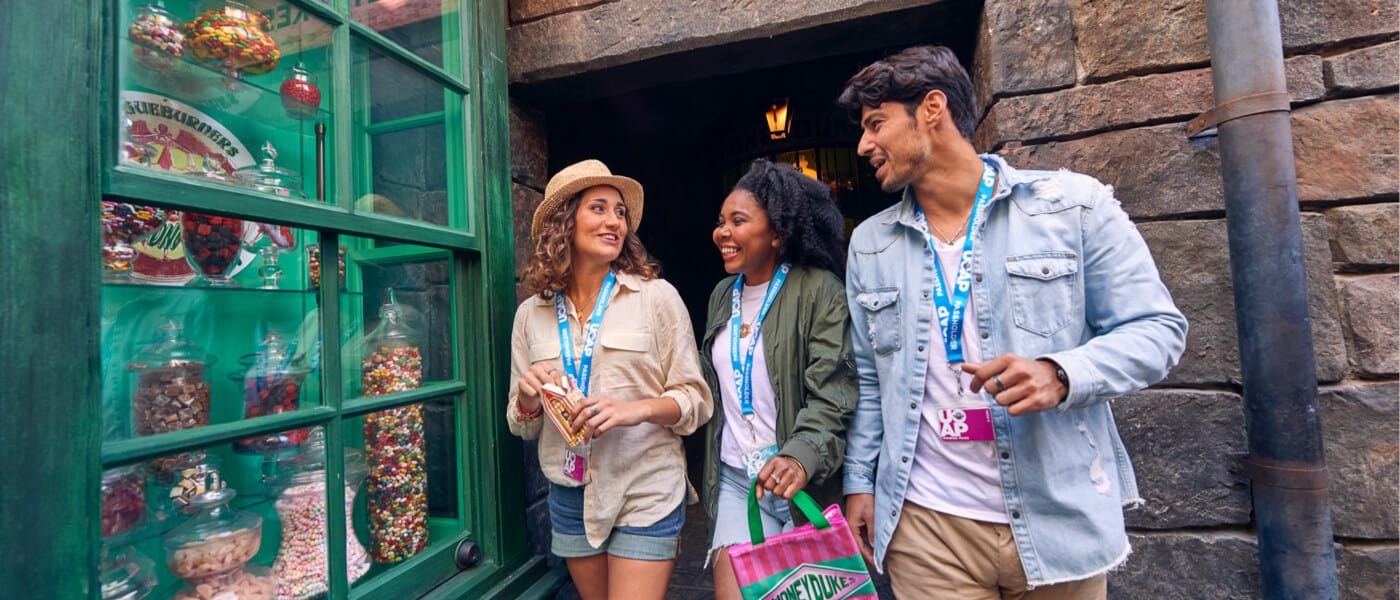 A group of three passholder friends shopping in The Wizarding World of Harry Potter™