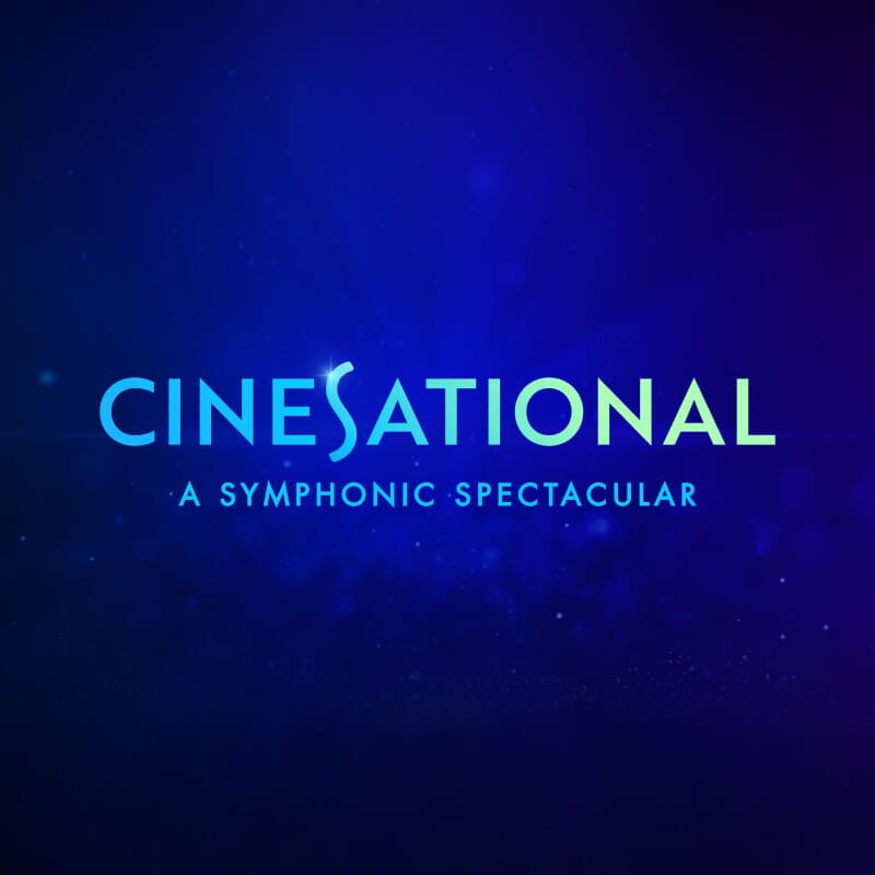 A royal blue background that fades into black with the words, "CINESATIONAL A SYMPHONIC SPECTACULAR" in the center.