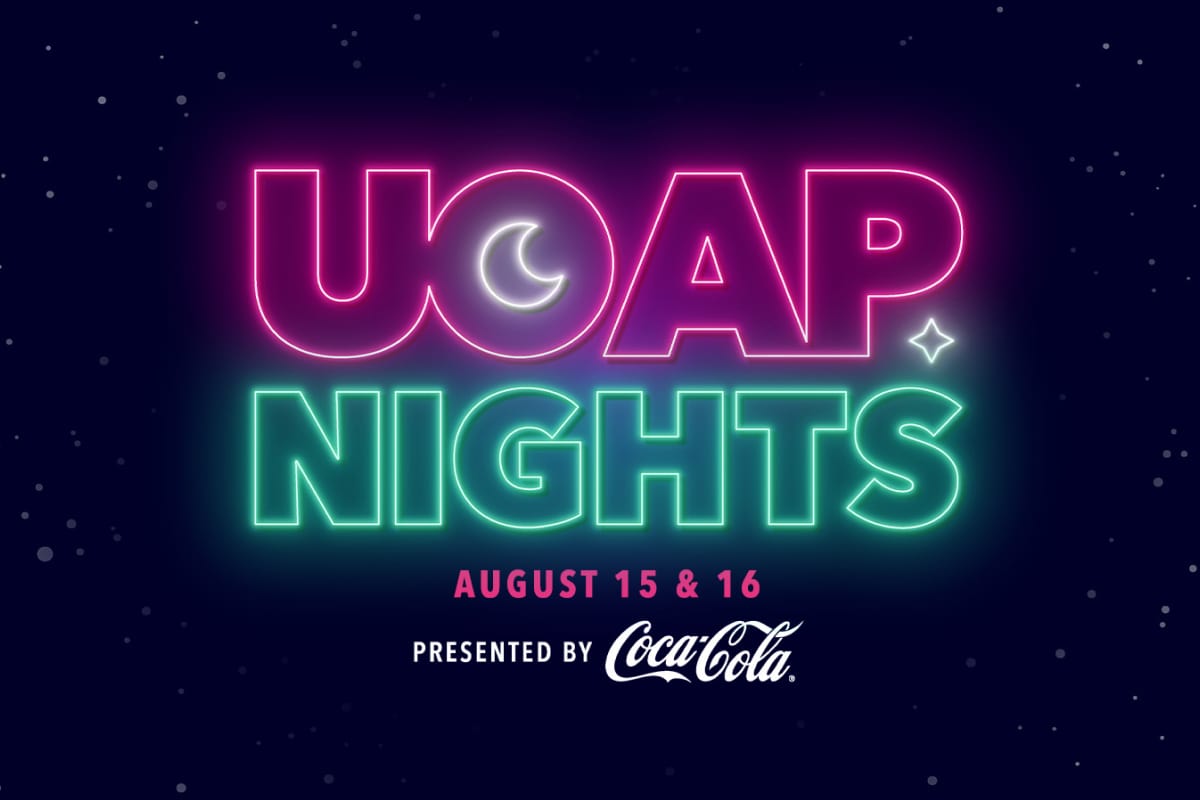 Pink&nbsp;and&nbsp;green&nbsp;neon&nbsp;letters&nbsp;spelling&nbsp;“UOAP&nbsp;NIGHTS,”&nbsp;with&nbsp;“AUGUST&nbsp;15&nbsp;&&nbsp;16”&nbsp;and&nbsp;“PRESENTED&nbsp;BY&nbsp;Coca-Cola”&nbsp;below,&nbsp;on&nbsp;a&nbsp;dark starry&nbsp;background.