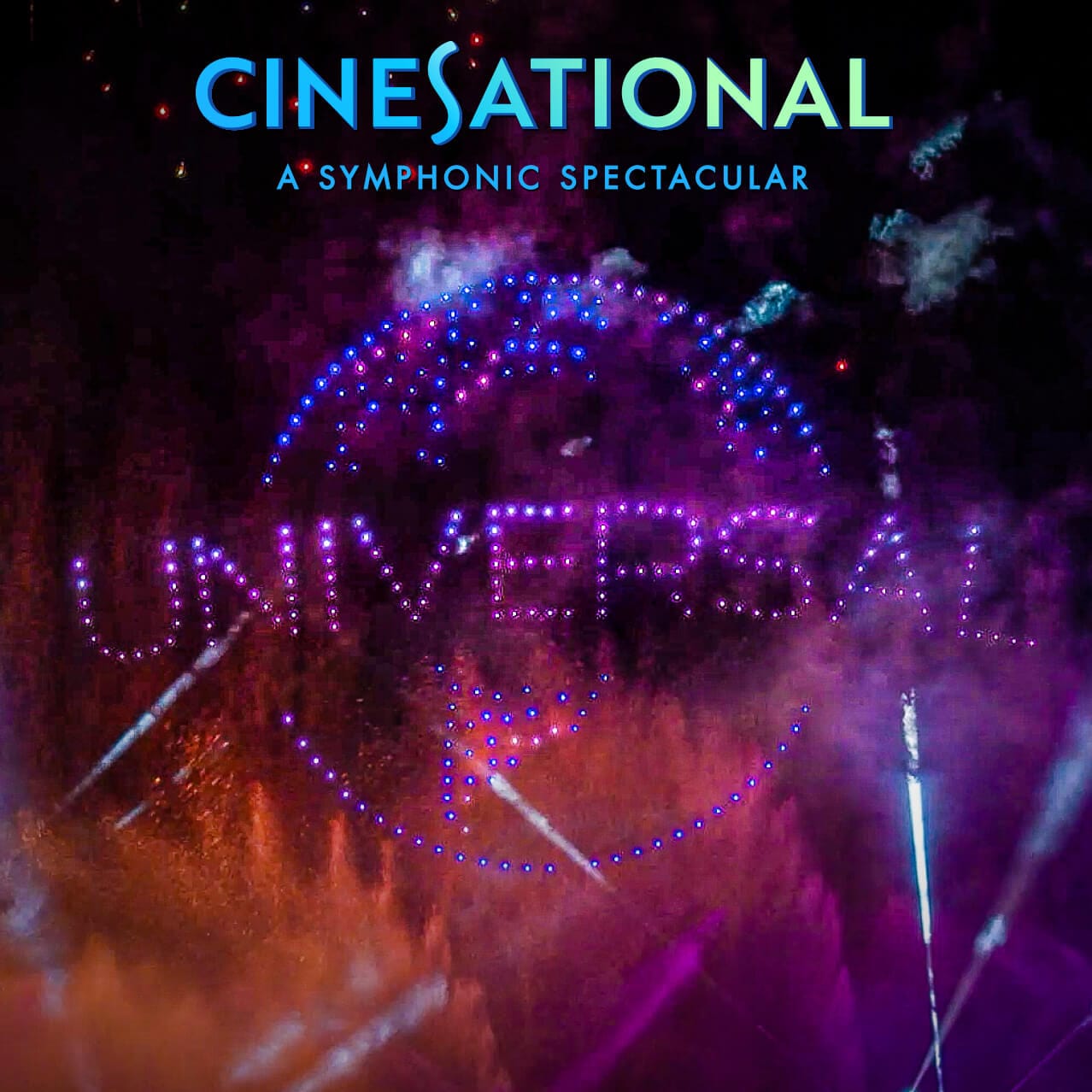 Colorful nighttime fireworks and drone lights forming the Universal logo.