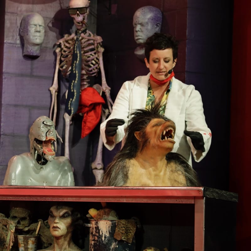 Team member on stage showing makeup for monsters