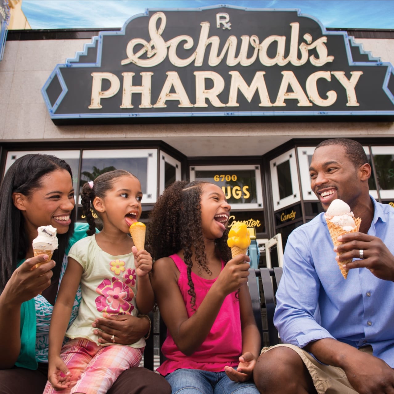A family in front of Schwab's Pharmacy eating ice cream cones