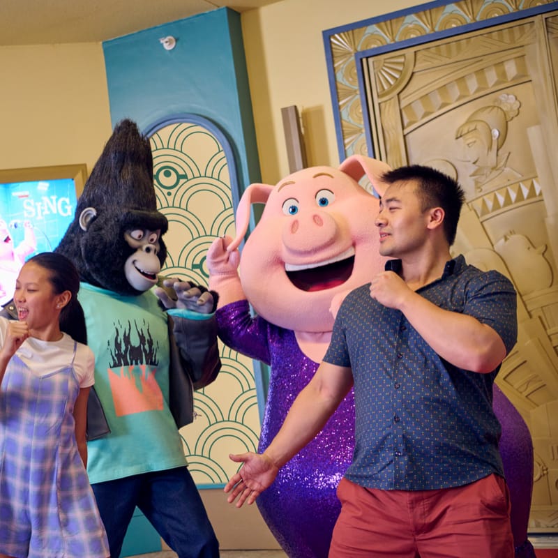 Two girls are seen dancing and smiling during the character encounter with Dave and Stuart who are Minions from the movie Despicable Me. The character encounter is located at the Illumination Theater at Universal Studios Florida.