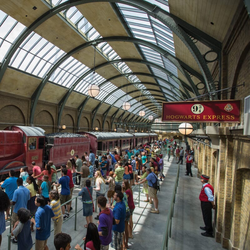 Guests at Universal Studios Orlando waiting to board the Hogwarts™ Express train ride in King's Cross Station.