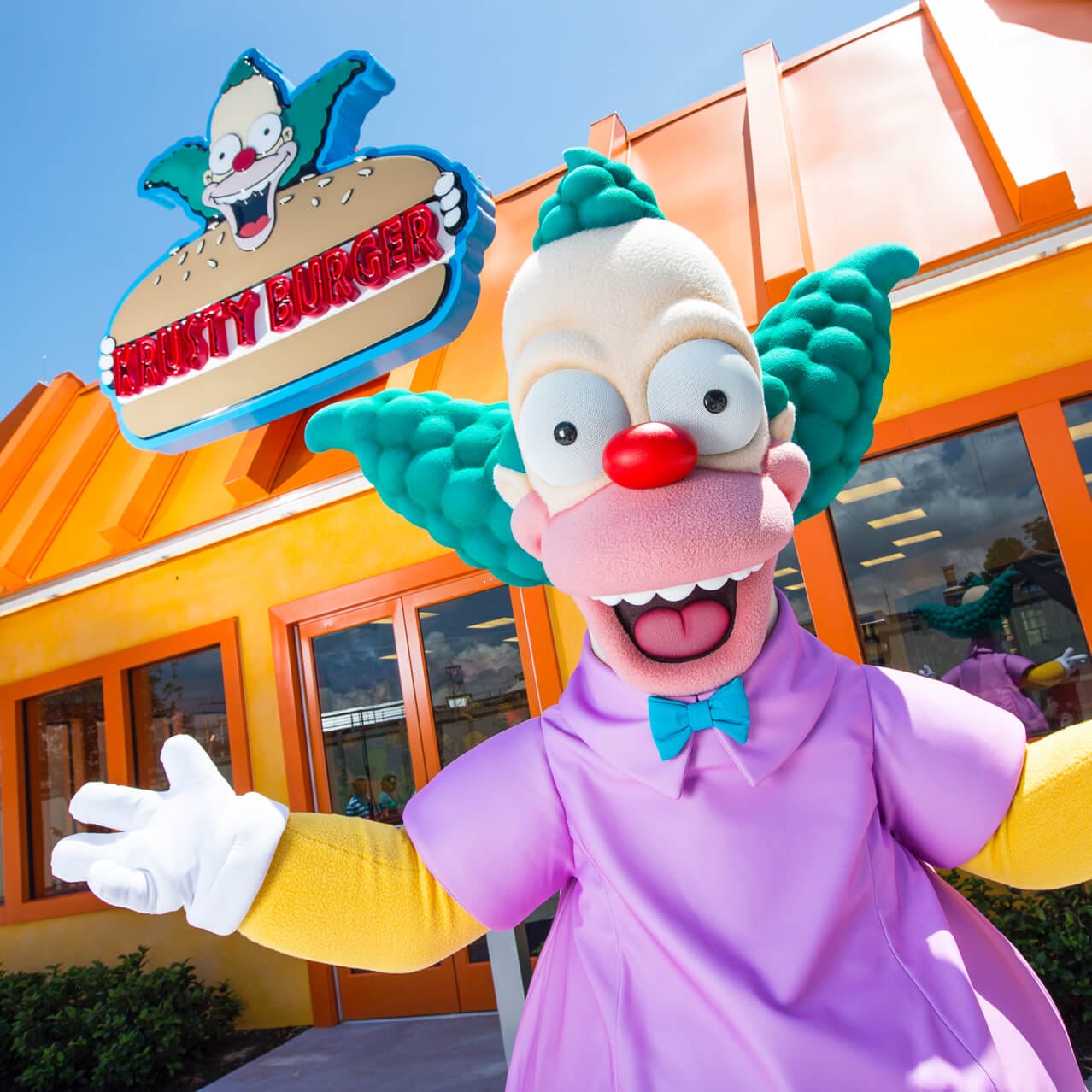 Krusty The Clown, famous character from The Simpsons TV show, welcomes you to his hamburger restaurant at Universal Studios Orlando.