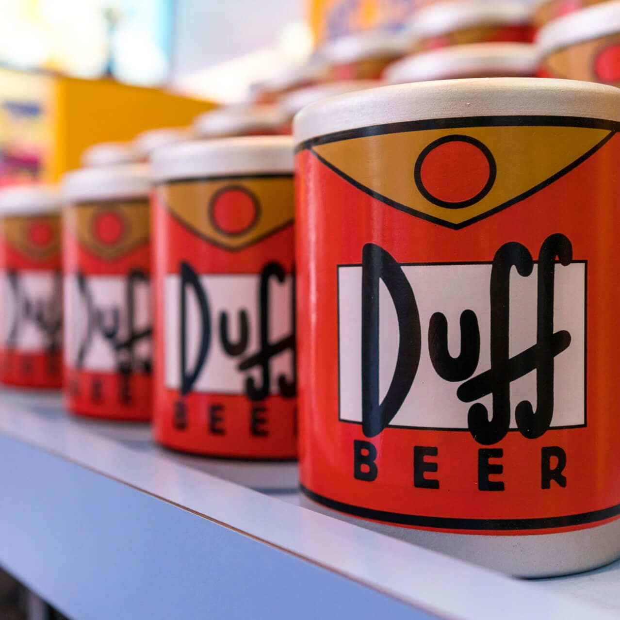 The interior of Kwik E Mart, a Simpsons themed souvenir shop at Universal Studios Orlando, featuring Duff shirts, Donut shaped pillows, and homer approved gifts.