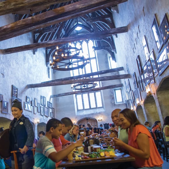 People enjoying traditional British food in the Leaky Cauldron restaurant in The Wizarding World of Harry Potter Diagon Alley at Universal Studios Orlando.