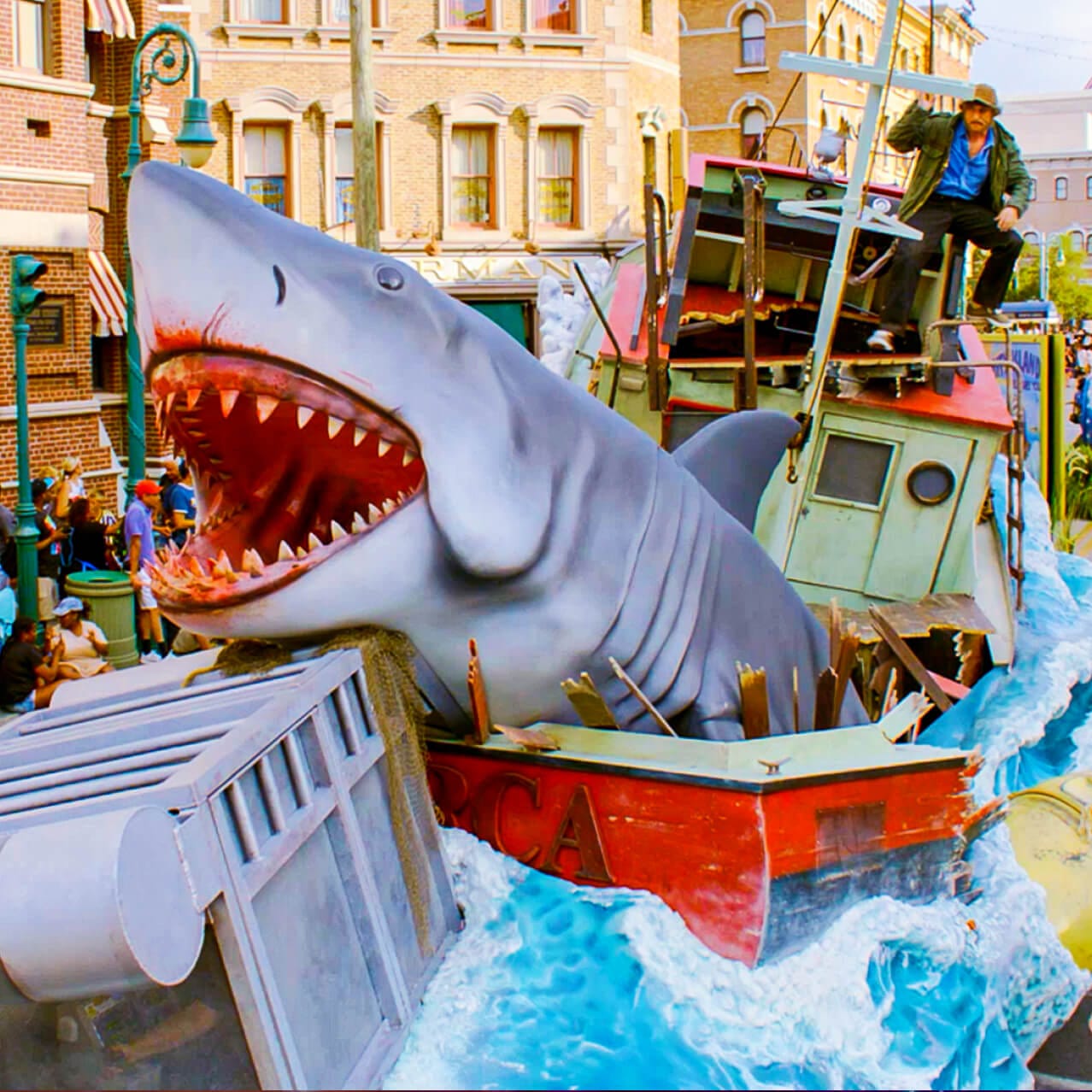 Parade float from Universal Mega Movie Parade with large animatronic shark bursting from a boat.