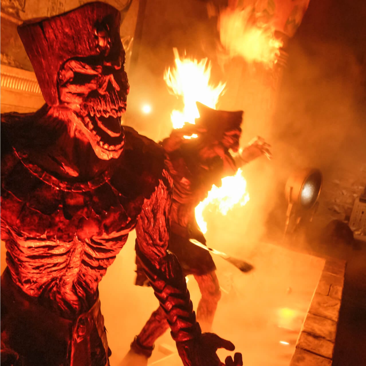 Warrior mummies silhouetted by blazing flames in Universal Studios Orlando's Revenge of the Mummy, a unique indoor coaster inspired by The Mummy film franchise.