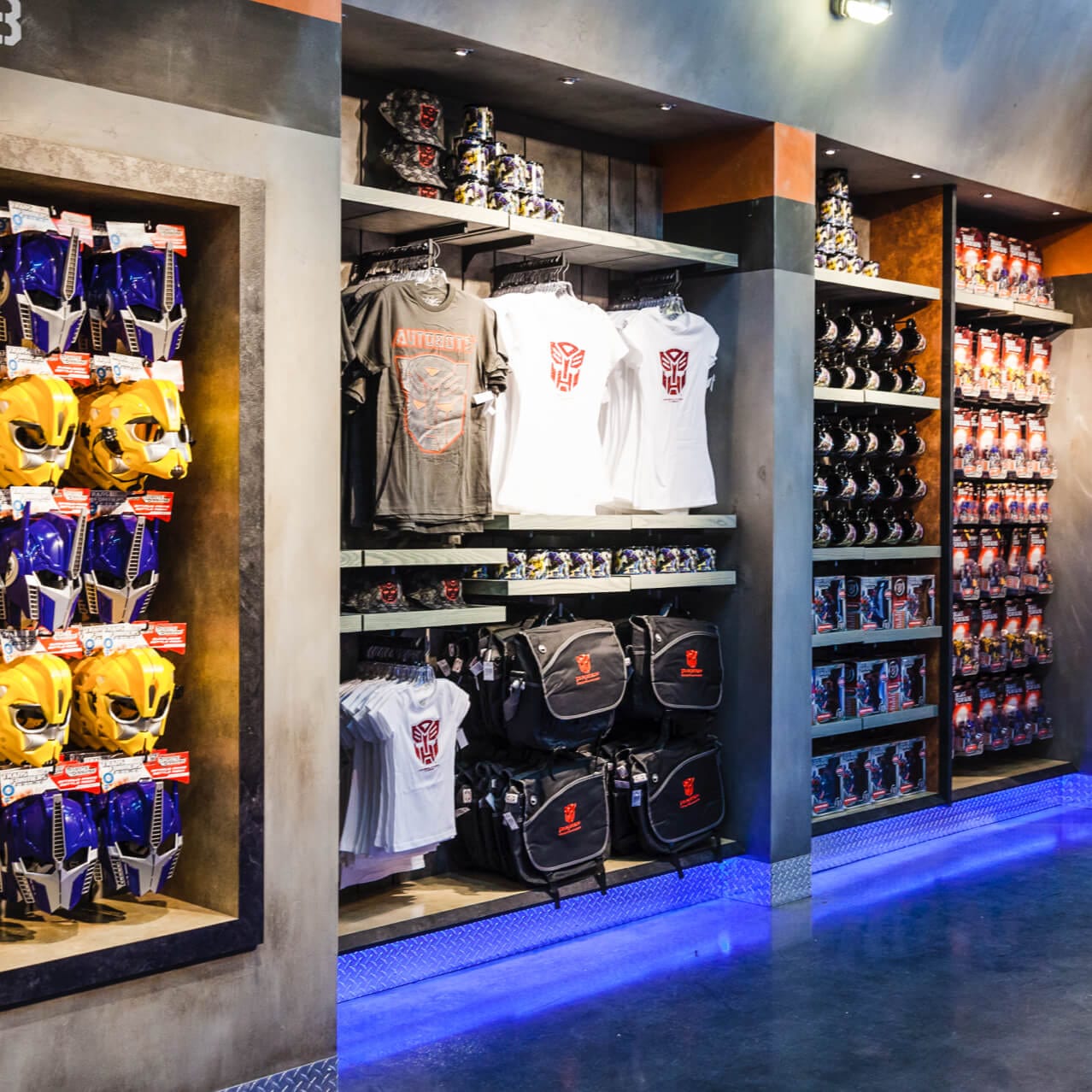 TRANSFORMERS themed apparel, mugs, toys, and Autobot masks on display at Supply Vault, a N.E.S.T inspired gift shop at Universal Studios Orlando.