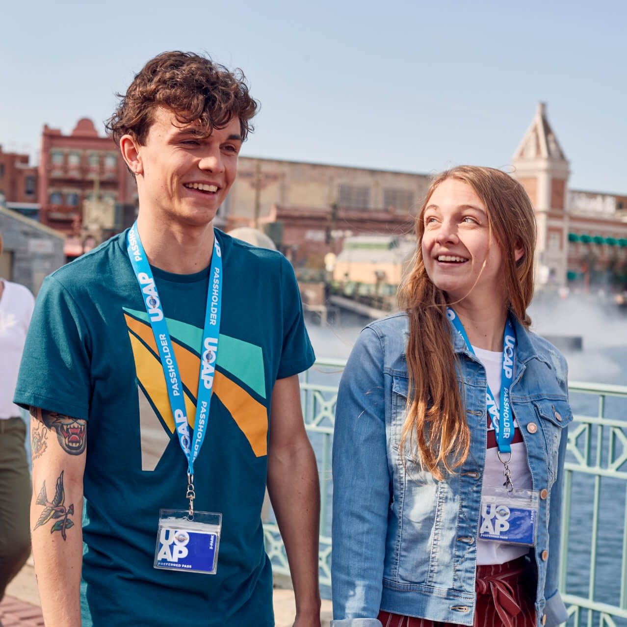 A family walks through Universal Studios Florida while wearing Universal Orlando Annual Passholder lanyards.