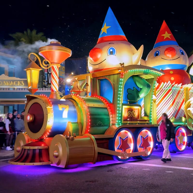 Parade float of the Macy’s Elf Train riding through the New York of Universal Studios Florida during Holidays at Universal Orlando.