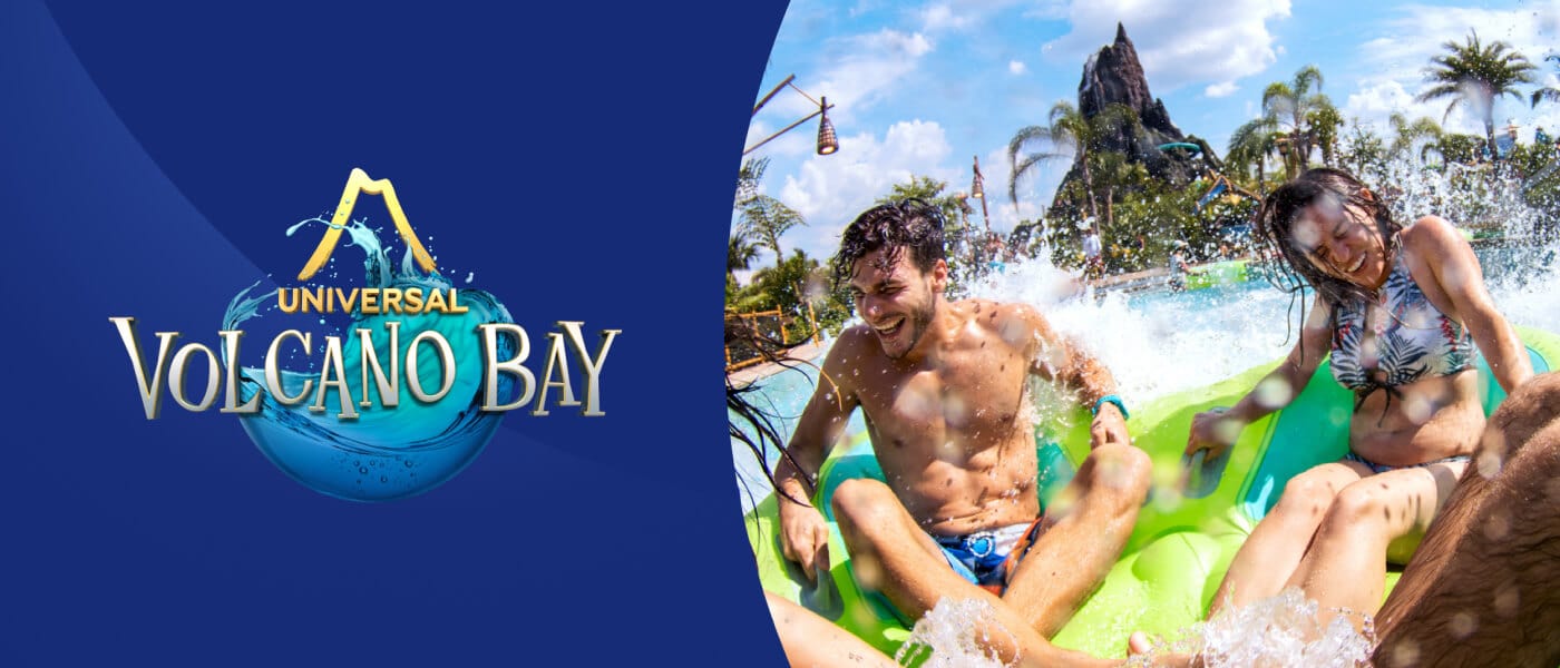 Riders hold on tight as they splash into the water on the River Village ride Honu of the Honu  ika Moana next to the Universal Volcano Bay logo.