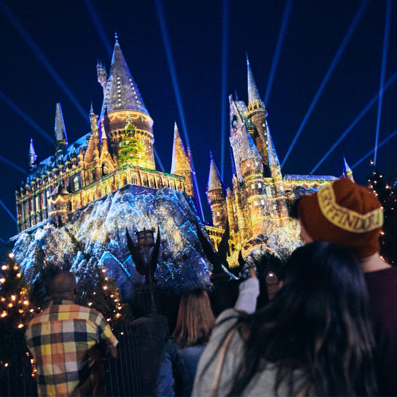 Guests viewing the castle projection show, “The Magic of Christmas at Hogwarts™ Castle” during the Holidays at Universal.