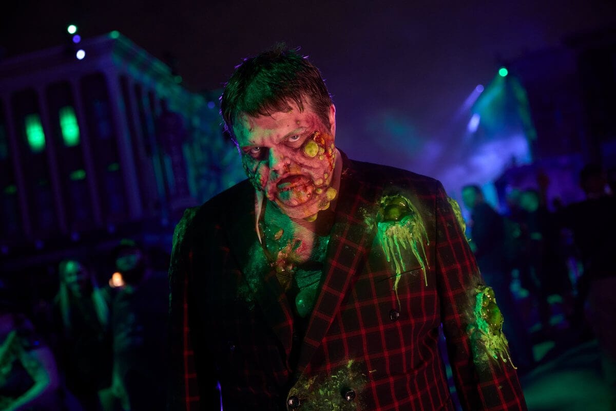 A scareactor in a checkered sportcoat covered in glowing green slime with boils on his face lurching about at night.