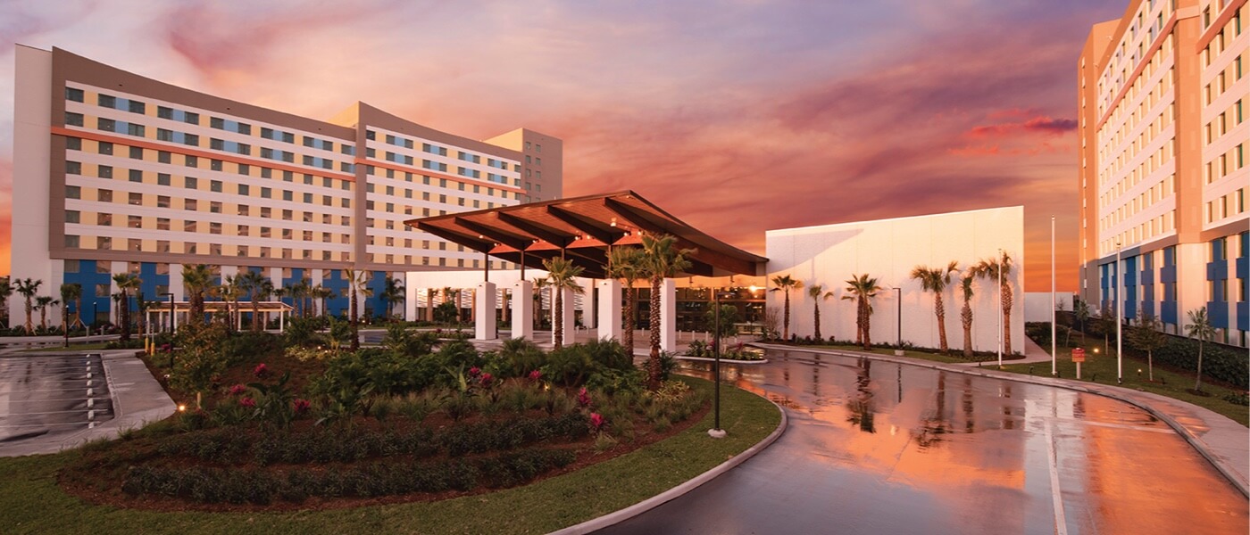 The sun sets on the entrance and exterior of Universal's Endless Summer Resort — Dockside Inn and Suites.