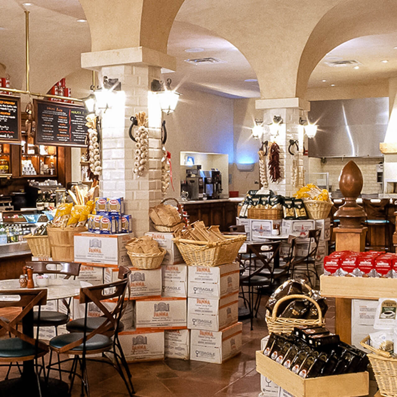 El interior de Sal's Market Deli rebosa calidez y encanto con mesas pequeñas, un mostrador para sándwiches y productos italianos para la venta.