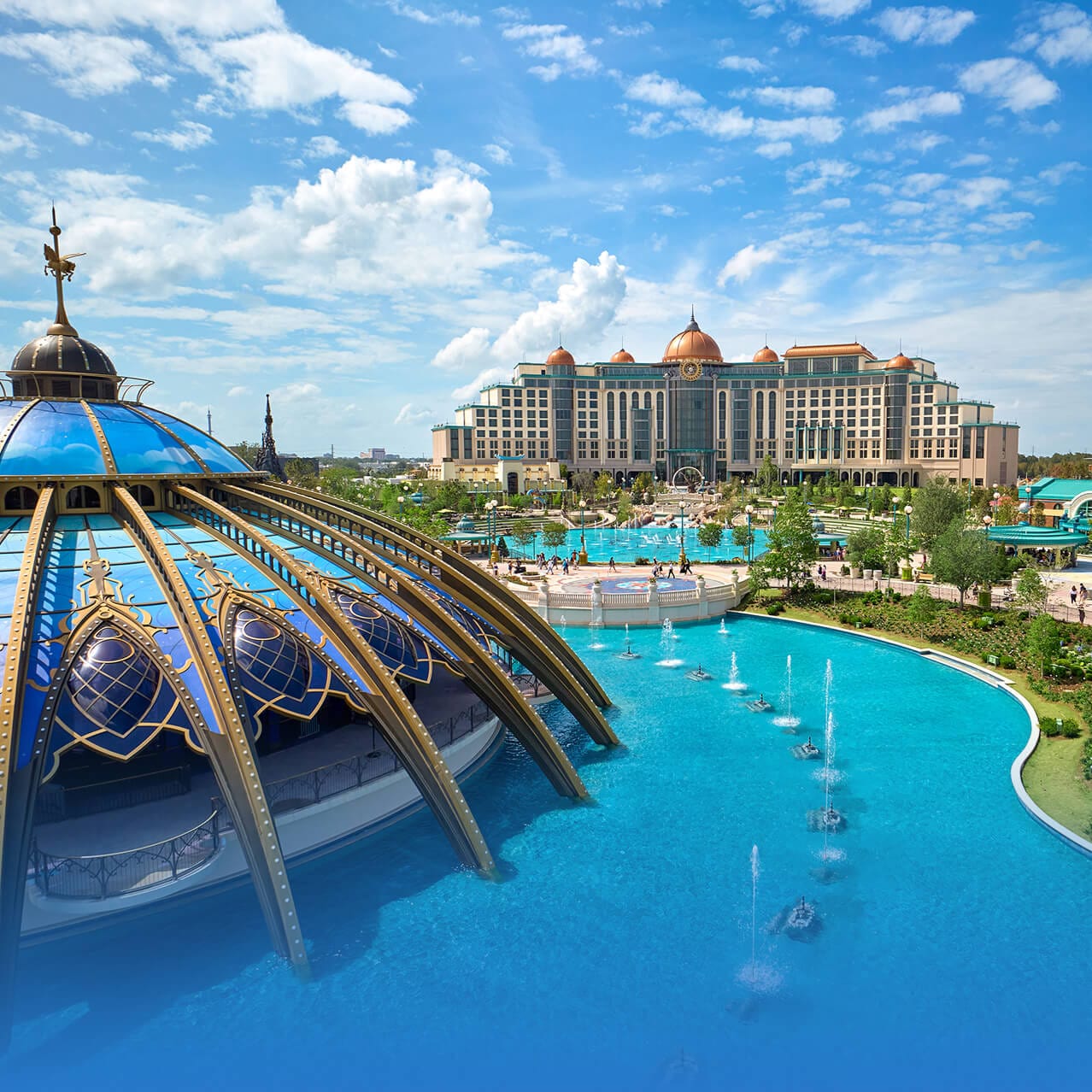 Vista de las numerosas atracciones acuáticas de Celestial Park con el Universal Helios Grand Hotel de fondo.