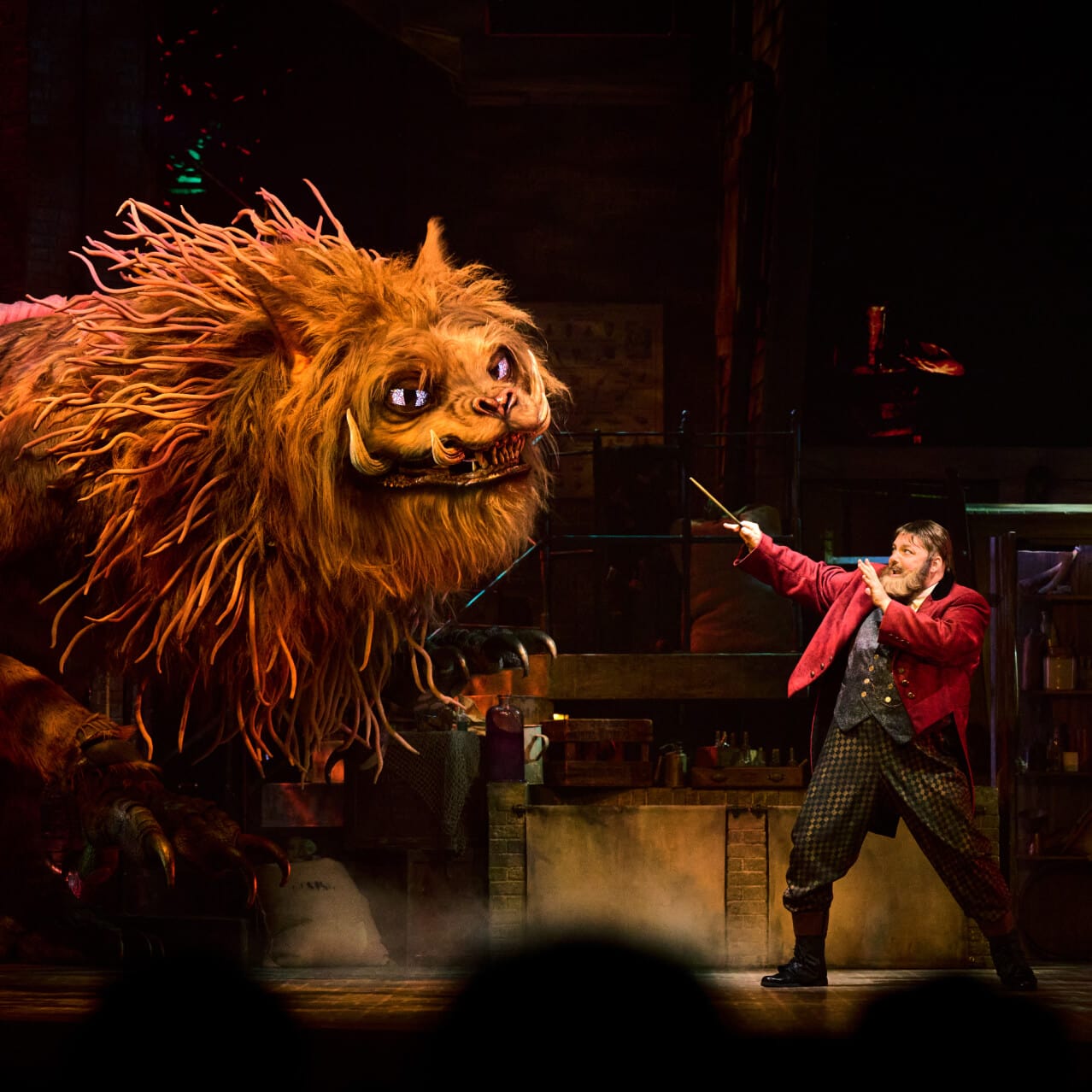 A giant magical Manticore steps toward ringmaster Skender on stage during a performance at Le Cirque Arcanus.