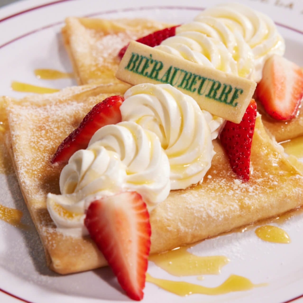 Butterbeer™ Crepe filled with shortbread cookie butter Bavarian cream, Butterbeer™ cream, strawberries and topped with a Butterbeer™ drizzle and a Butterbeer™ shortbread cookie served at Café L’air De La Sirène.