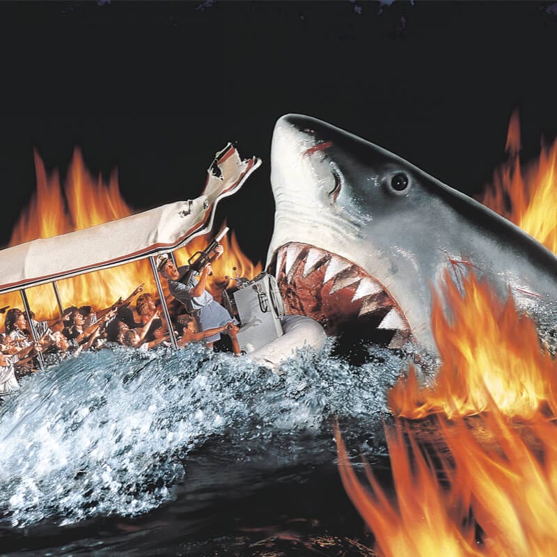 En esta antigua atracción de Universal Studios Florida, el inmenso y legendario tiburón blanco de Jaws muerde un bote lleno de gente, rodeado de llamas.