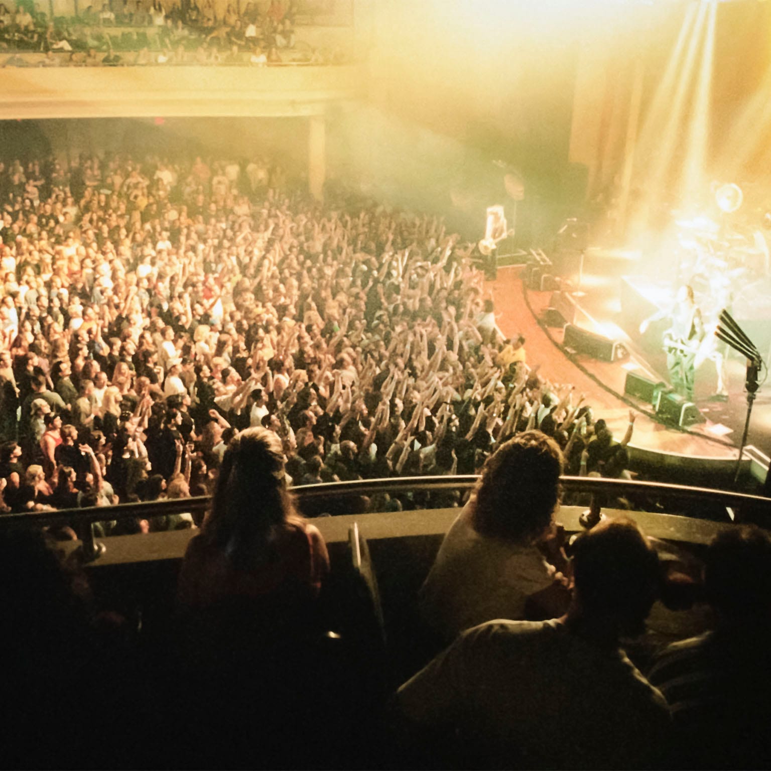 Looking down from the balcony seats inside Hard Rock Live onto the crowd below viewing a brightly lit concert.