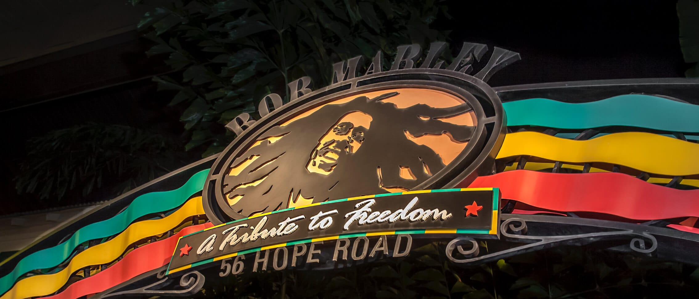 Bob Marley sign with “A Tribute to Freedom” and “56 Hope Road,” decorated in red, yellow, and green.