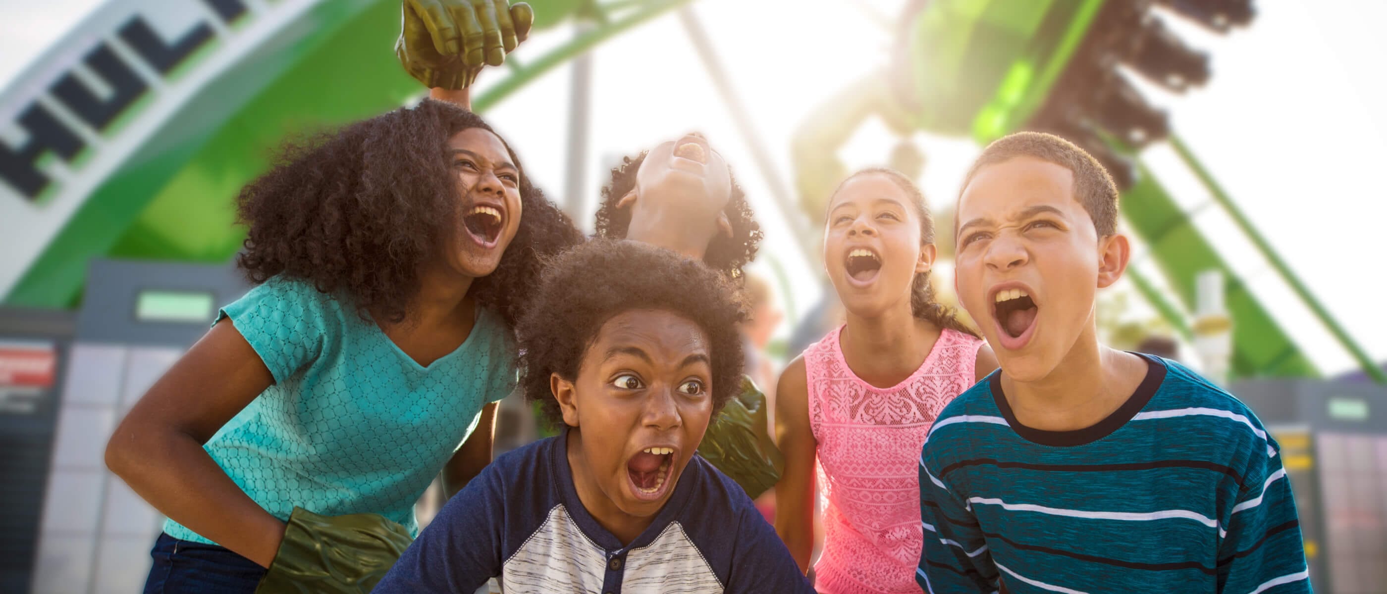 A group of five kids playing as Hulk at the entrance of The Incredible Hulk Coaster in Universal Islands of Adventure.