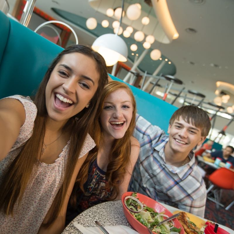 Youth taking selfies at the Bayliner Diner