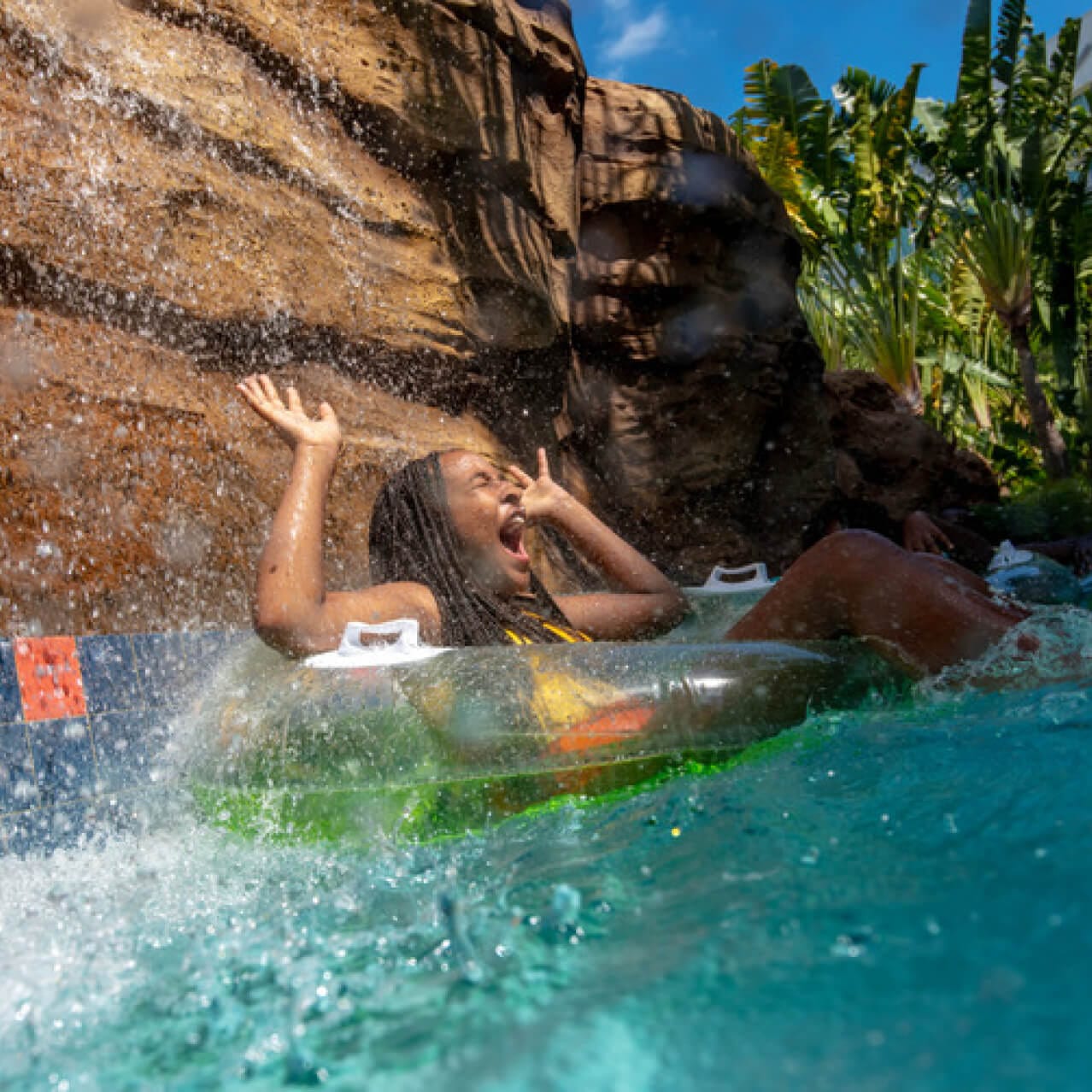 Youth floating in the lazy river and laughing