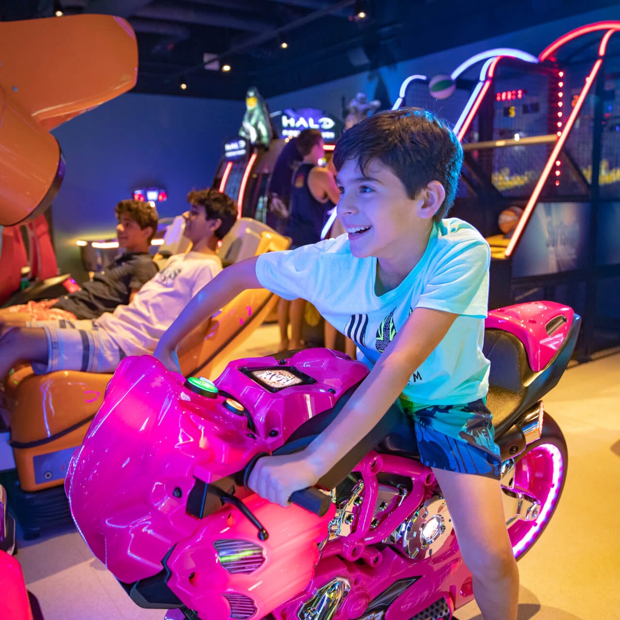 Boy riding bike in arcade.