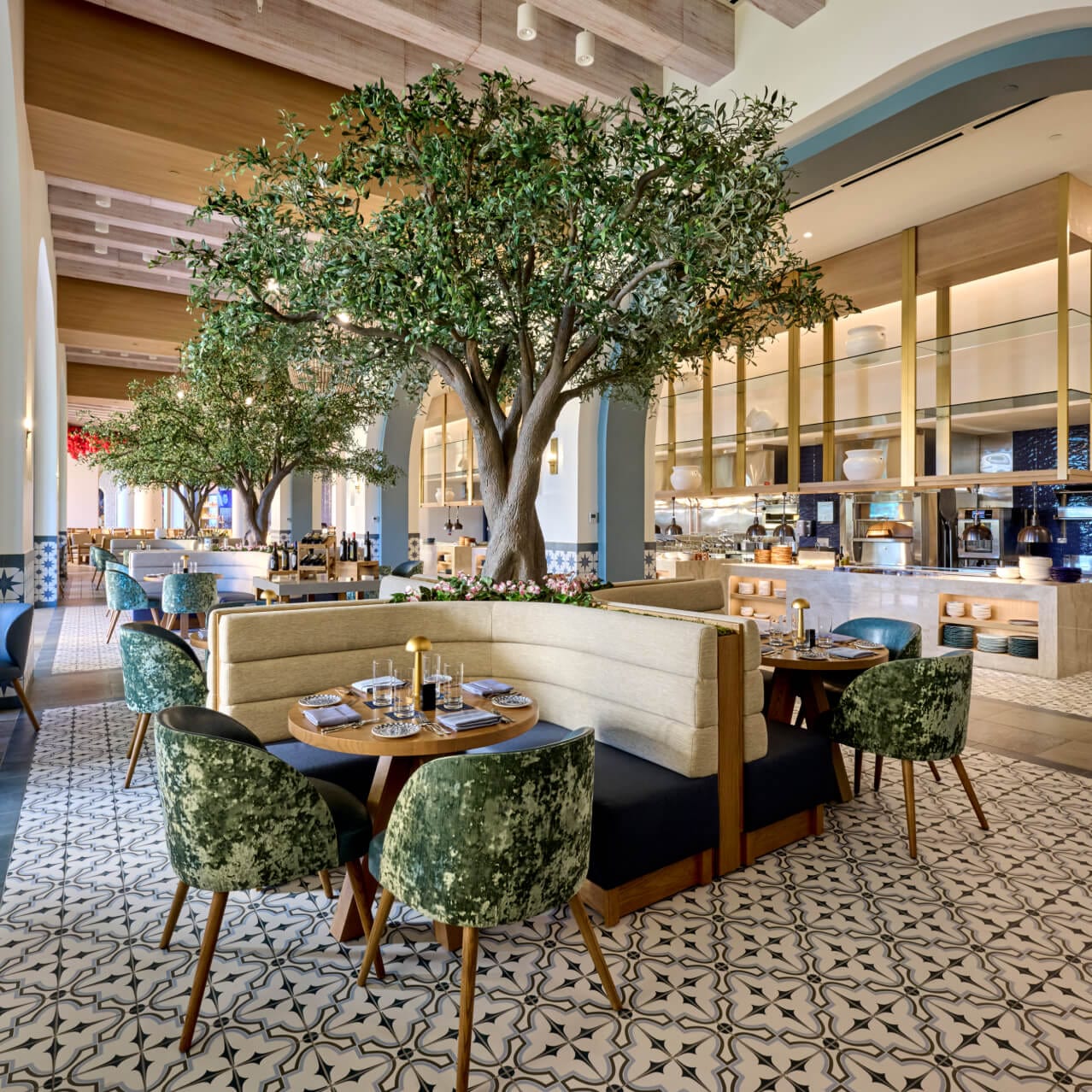 The Mediterranean-themed Flora Taverna at Universal Helios Grand Hotel, with mini trees and floral decor. 
