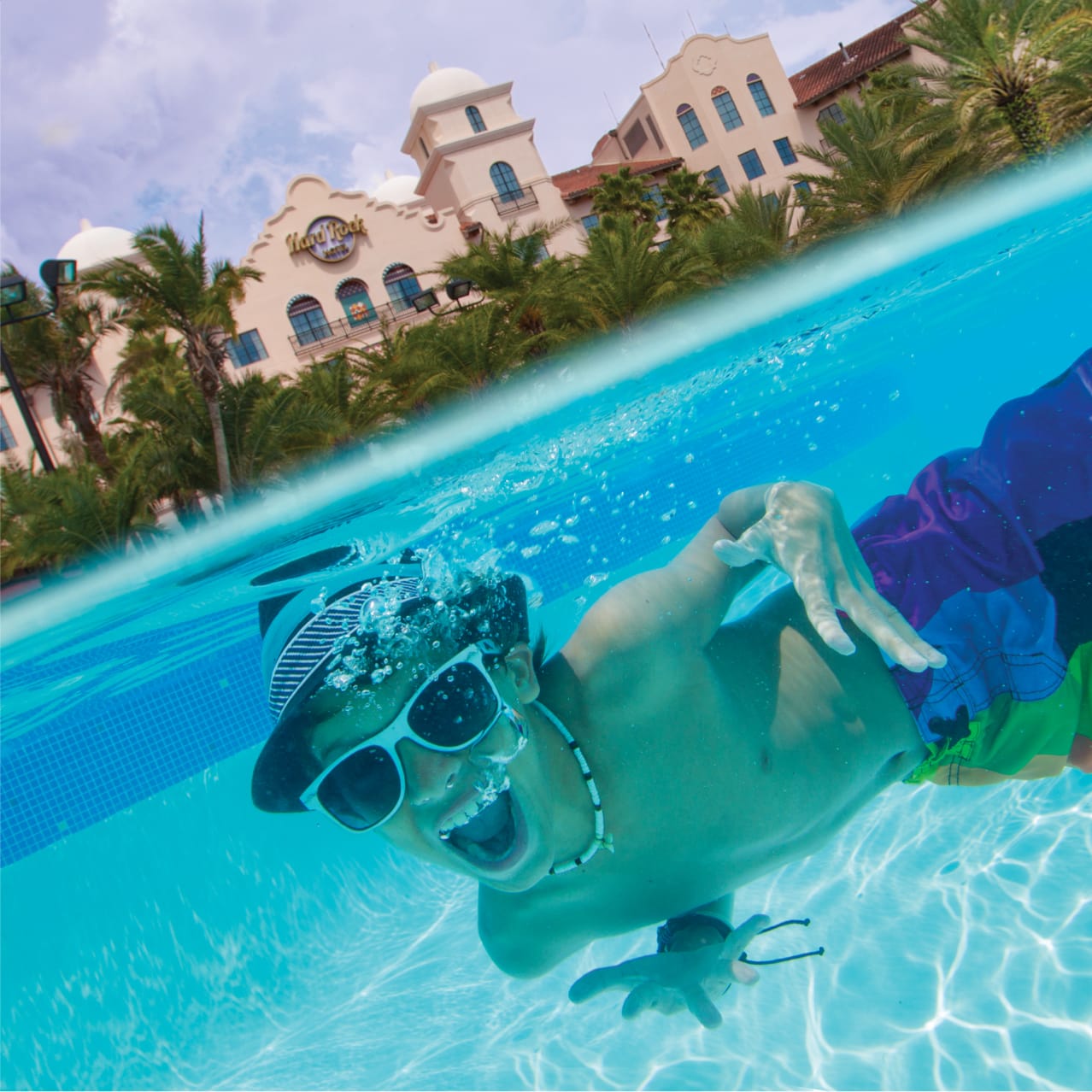 A boy underwater listening to music in the pool at the Hard Rock Hotel