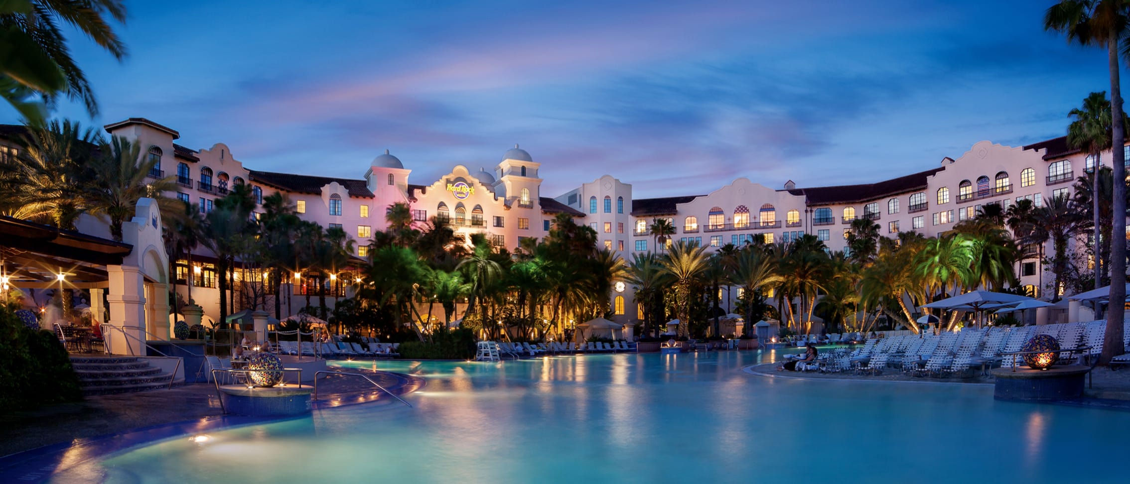 An external view of the Hard Rock Hotel pool area at dusk