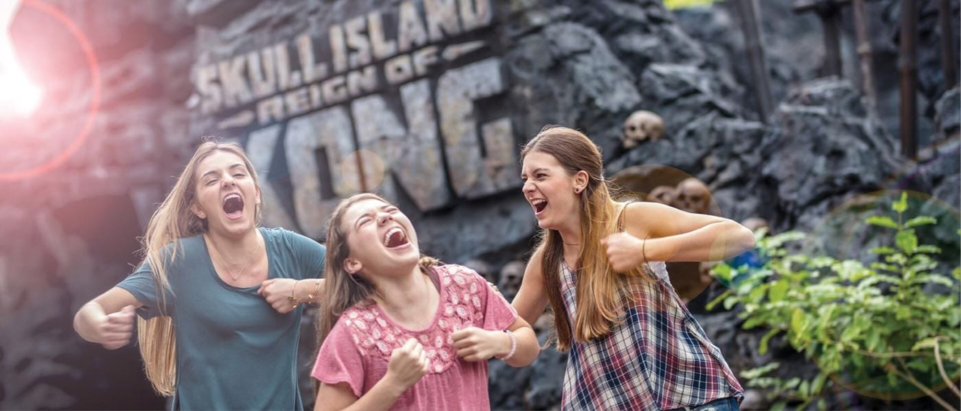 Teens mimicking Kong in front of Skull Island Reign of Kong