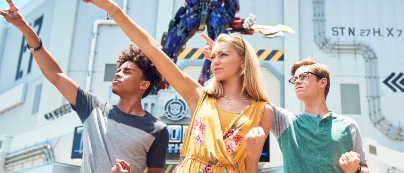 3 teens posing in front of Transformers: The Ride 3D