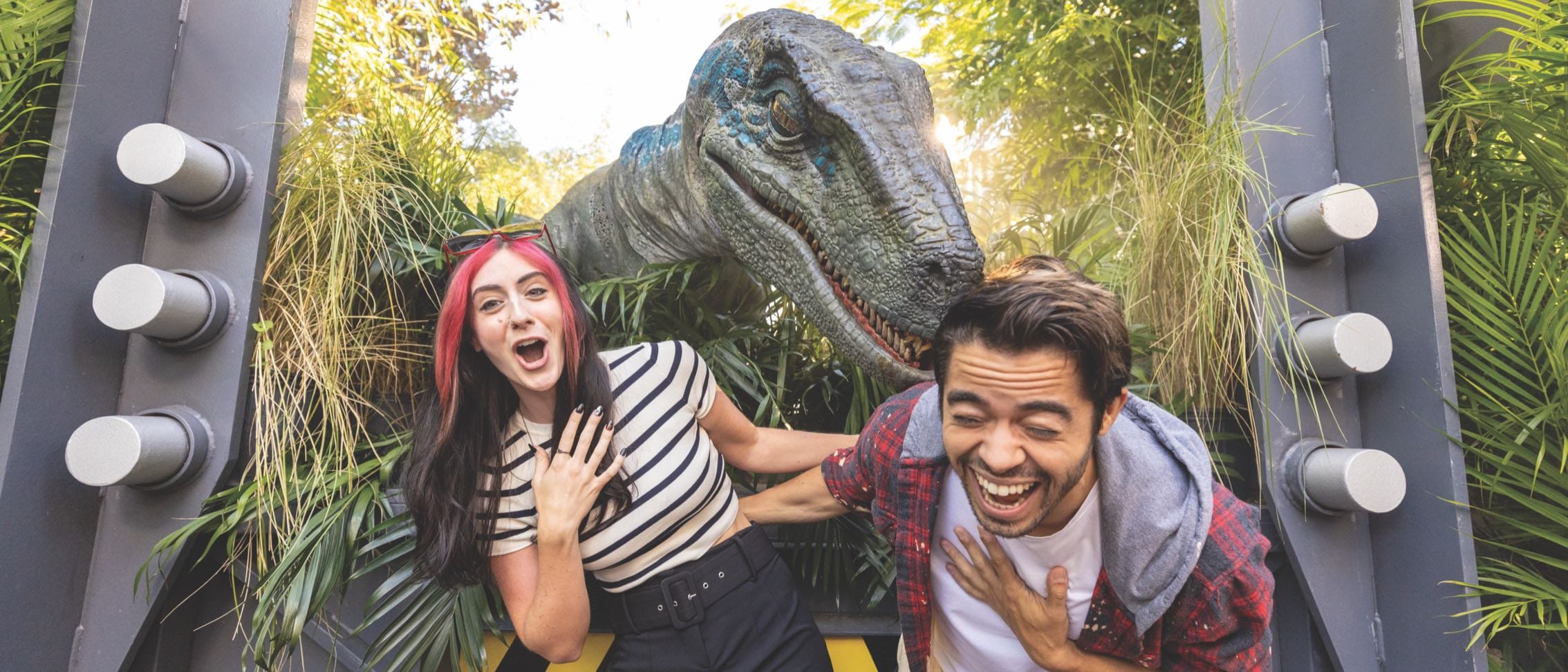 A couple laughs at the Jurrasic Park Raptor