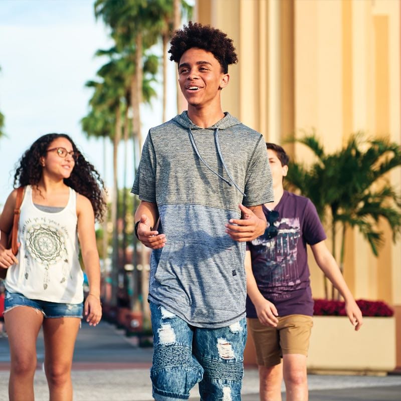 Youth walking near the arch