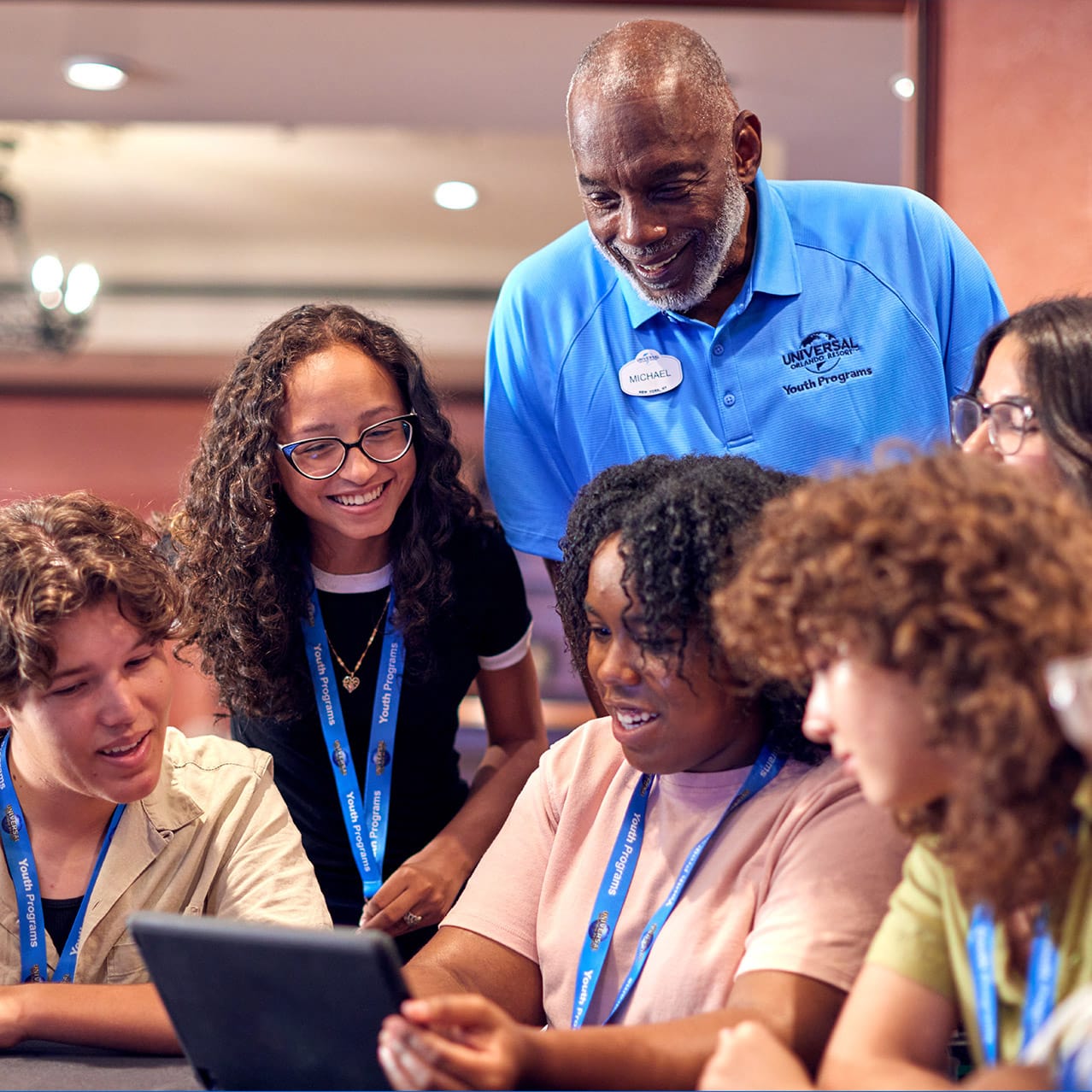 A group of teens work with an instructor at a youth program workshop in Universal Studios Orlando.