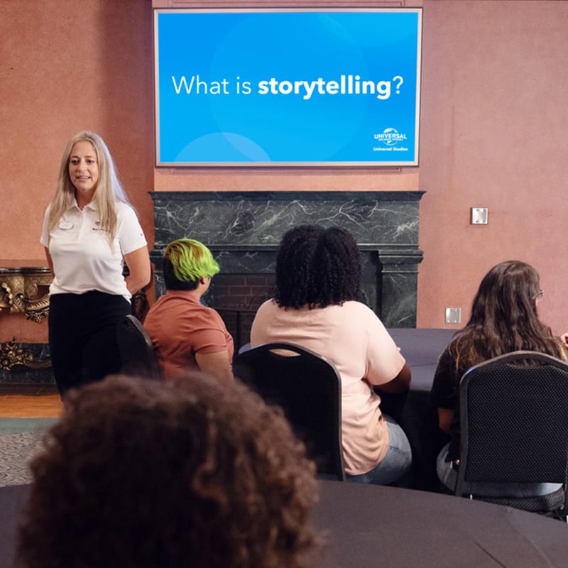 An instructor gives students a lesson on storytelling at a youth program workshop in Universal Studios Orlando.