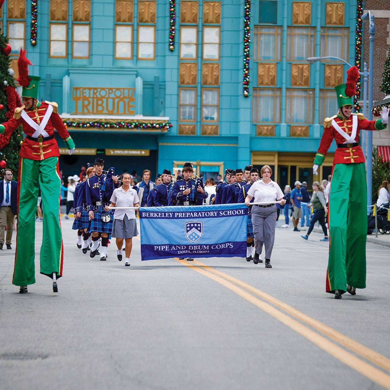 A student marching band performing at Universal’s Holiday Parade featuring Macy's in Universal Studios Florida.