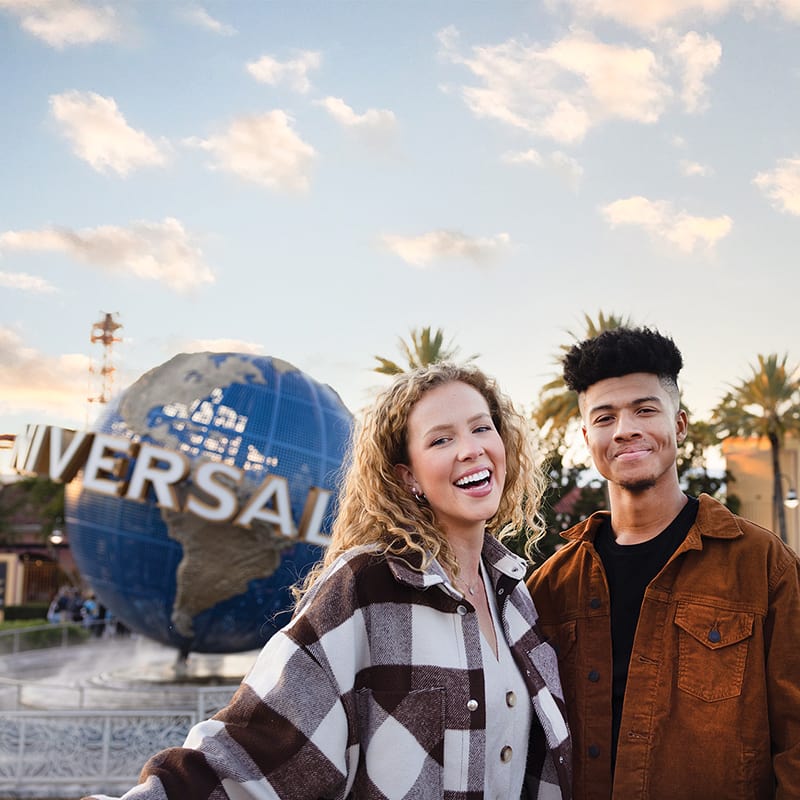College students pose for photos at the Globe and Arch at Universal Studios Florida.