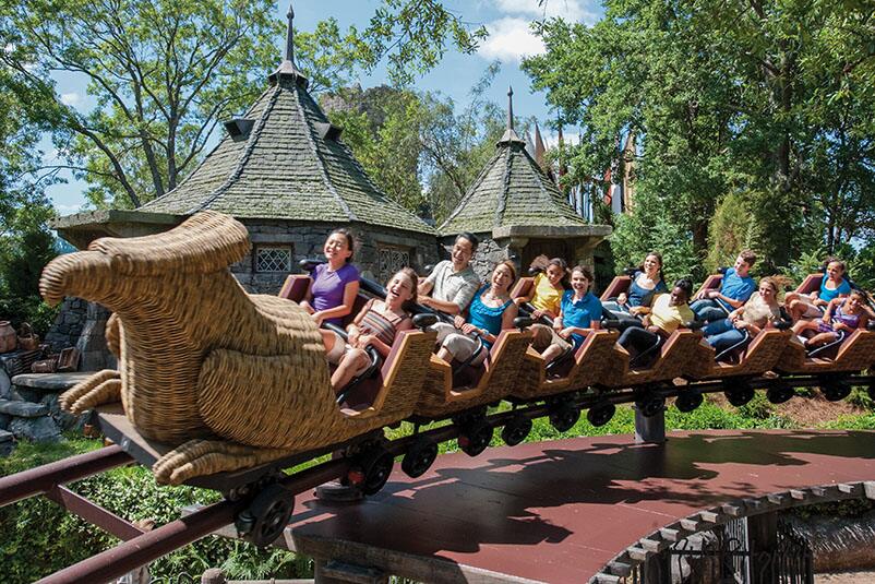 Swoop past Hagrid's pumpkin patch on the family friendly Harry Potter themed roller coaster Flight of the Hippogriff. Young theme park guests and their families enjoying the mild roller coaster fun of Flight of the Hippogriff at The Wizarding World of Harry Potter in Universal's Islands of Adventure in Orlando.
