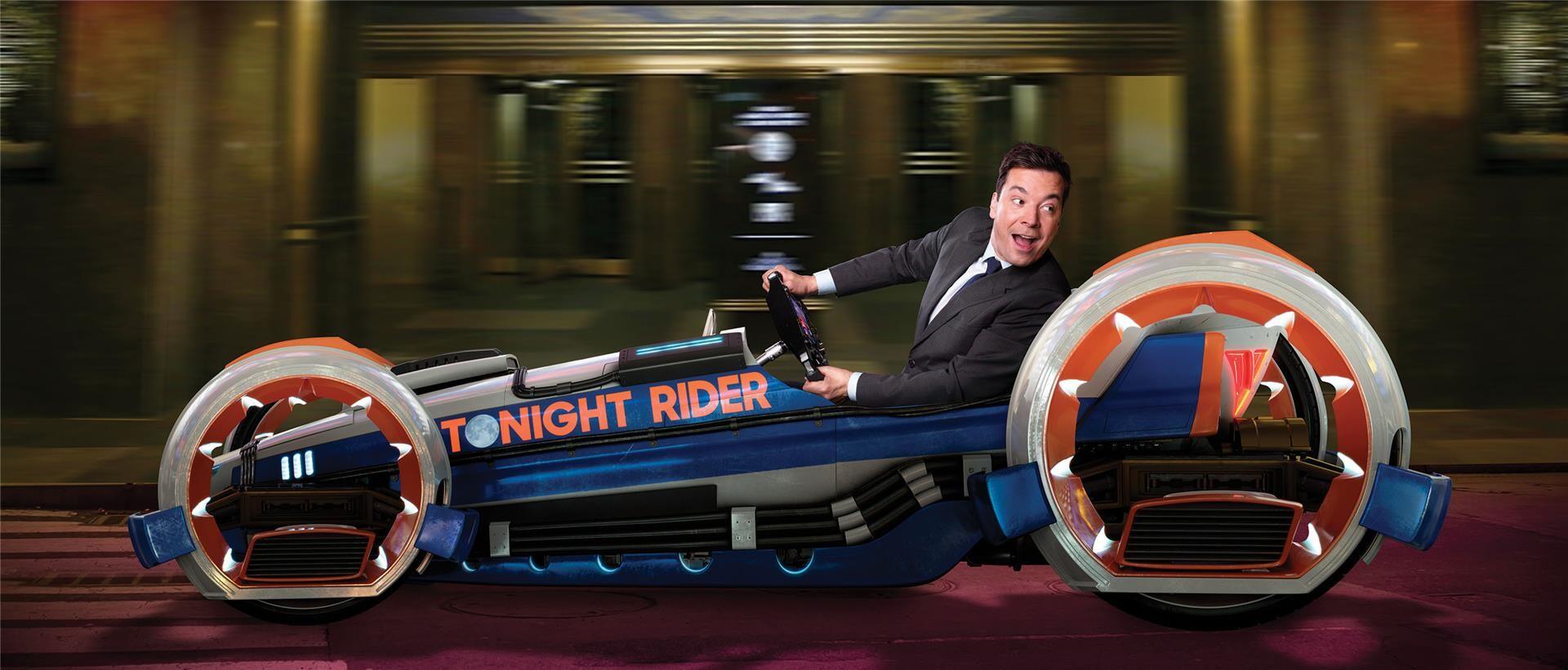 Jimmy Fallon Looks Back Over His Shoulder As He Speeds Along In A Blue And Red Jimmy Fallon Looks Back Over His Shoulder As He Speeds Along In A Blue And Red